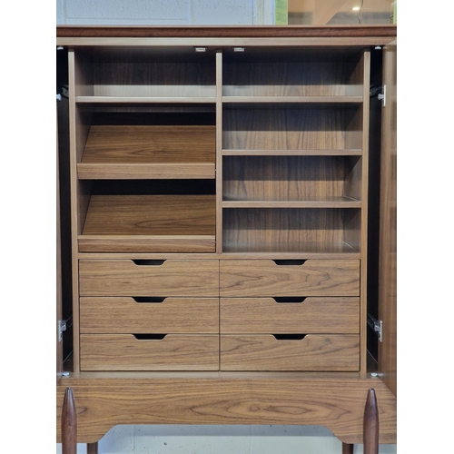 2257 - Contemporary Danish style teak two door cabinet, the interior fitted with an arrangement of drawers ... 