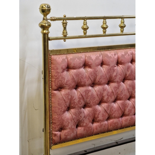 2425 - Victorian brass bedstead with iron side rails, cushioned headboard and studded edging raised on cera... 