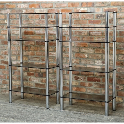 2243 - In the manner of Merrow Associates - pair of vintage chrome and smoked glass shelving units, five ad... 