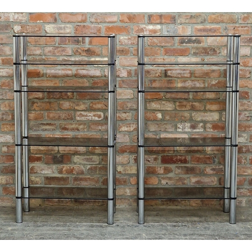 2243 - In the manner of Merrow Associates - pair of vintage chrome and smoked glass shelving units, five ad... 