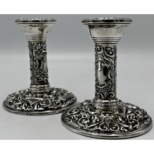 1163 - Pair of 1960s silver Victorian style embossed candlesticks, maker B & Co, Birmingham 1964, 10cm high