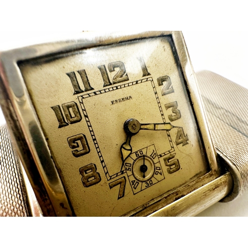 1007 - Good early 20th century engine turned silver purse clock by Eszeha, 5.5cm long