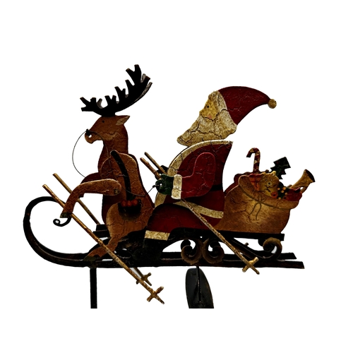 411 - Painted metal rocking toy of Santa and reindeer on a sleigh, 45cm high