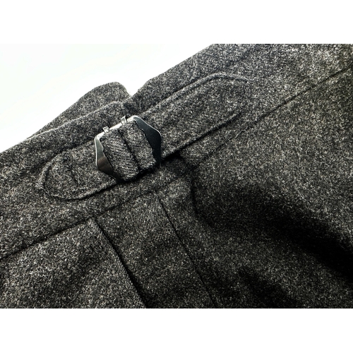 498 - A black wool suit by Pakeman Catto & Carter with a further pair of black wool trousers