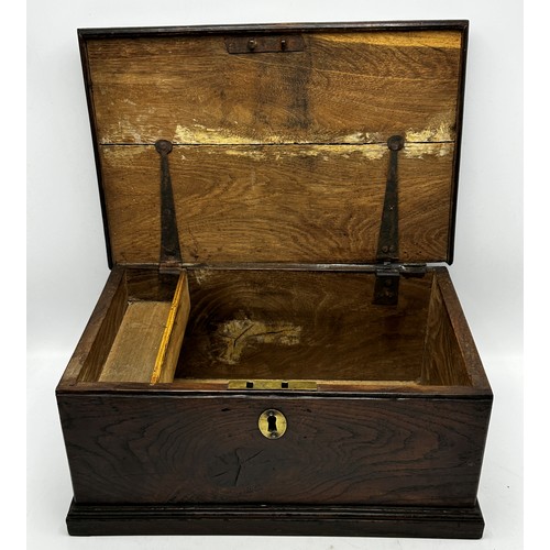 289 - 18th century elm candle box, the hinged lid enclosing a fitted interior, 18cm high x 39cm wide