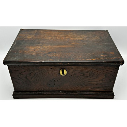 289 - 18th century elm candle box, the hinged lid enclosing a fitted interior, 18cm high x 39cm wide