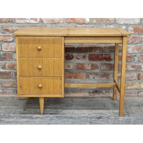 1142 - 1950s teak desk / dressing table, the hinged top with mirror to the reverse and three drawers, H 69c... 