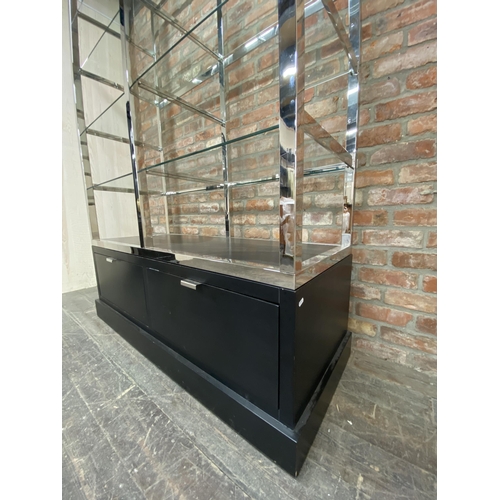 1208 - India Jane of London 'Soho' display unit, eight heavy glass shelves on a chrome frame with ebonised ... 