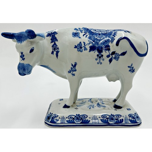 2192 - Two graduated pairs of Delft blue and white porcelain cows with a further Imari pattern example, the... 