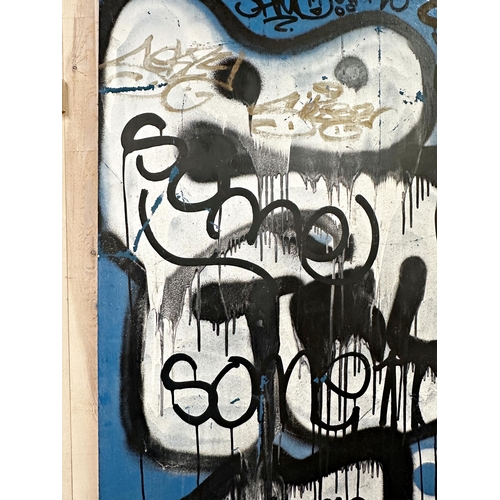 1169 - 21st century school - Large door panel with graffiti paint of figure and tags, 193 x 75cm