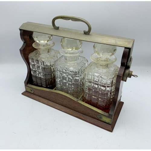 2341 - Antique Oak Wood Three Bottle Tantalus With Crystal Decanters & Key