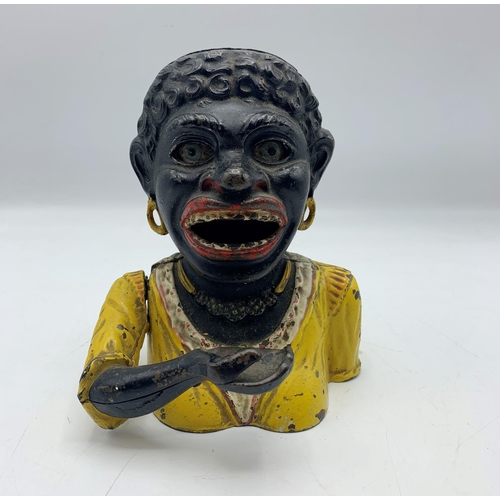 2389 - Unusual female Jolly Negro cast iron money bank.