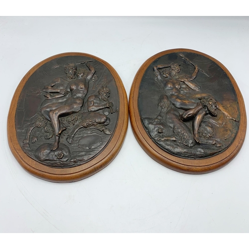 2392 - Pair of bronze oak mounted plaques depicting Nude Lady With The Devil. L 30cm.