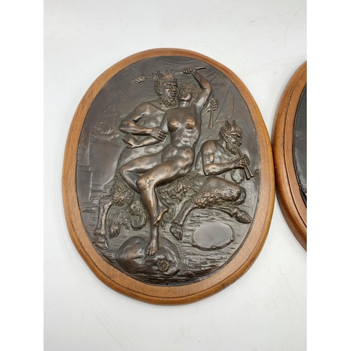 2392 - Pair of bronze oak mounted plaques depicting Nude Lady With The Devil. L 30cm.