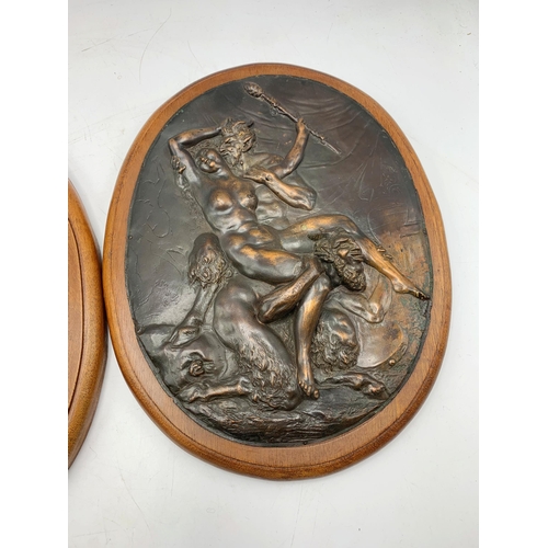 2392 - Pair of bronze oak mounted plaques depicting Nude Lady With The Devil. L 30cm.