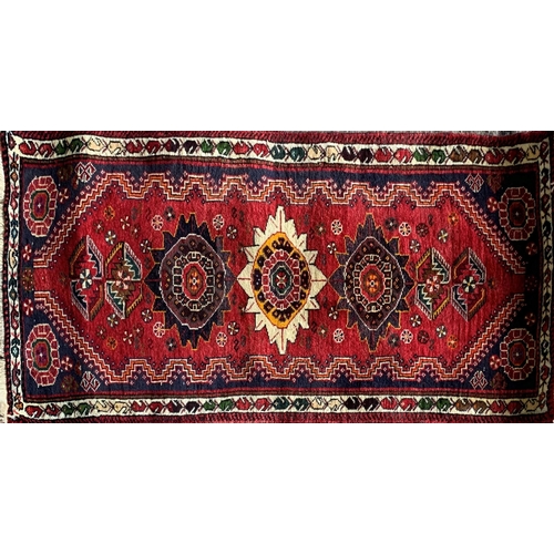 1431 - Persian thick pile Qashgai rug, three medallions on red ground, 170 x 75cm