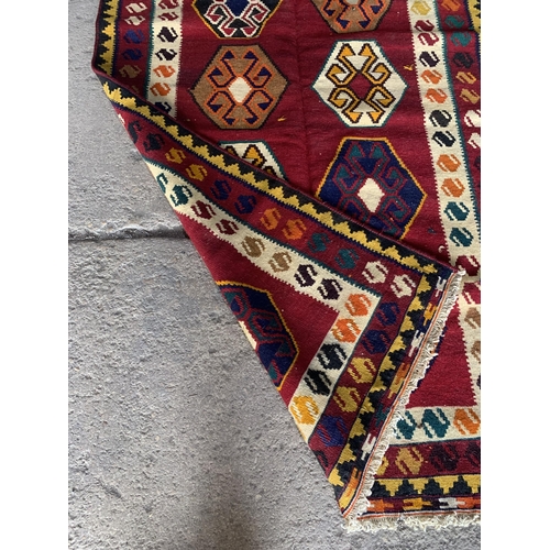 1434 - Good quality Persian Qashgai kilim, ten medallions on red ground, 250 x 140cm