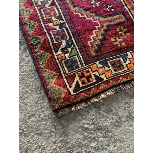 1435 - Good quality Persian Lori rug, bespoke medallion design on purple ground, 270 x 130cm