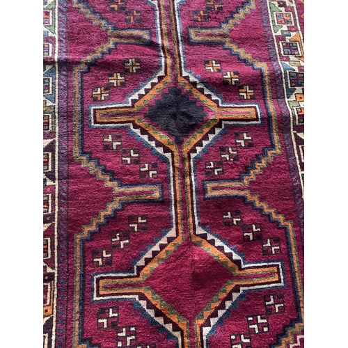 1435 - Good quality Persian Lori rug, bespoke medallion design on purple ground, 270 x 130cm