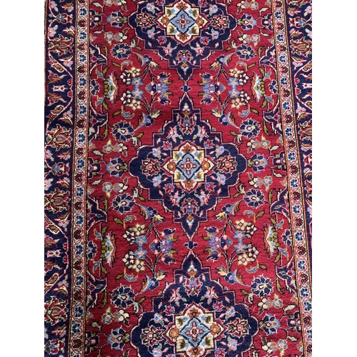 1437 - Persian Kashan runner, traditional four medallion design on red ground, 290 x 100cm