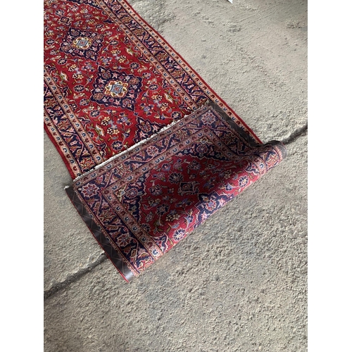 1437 - Persian Kashan runner, traditional four medallion design on red ground, 290 x 100cm