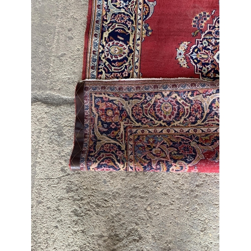 1443 - Traditional Persian Kashan rug, central blue medallion on red ground, 220 x 130cm