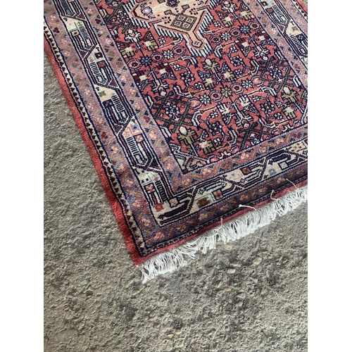 1445 - Good Persian Malayer runner, intricate three medallion design on washed red ground, 285 x 90cm