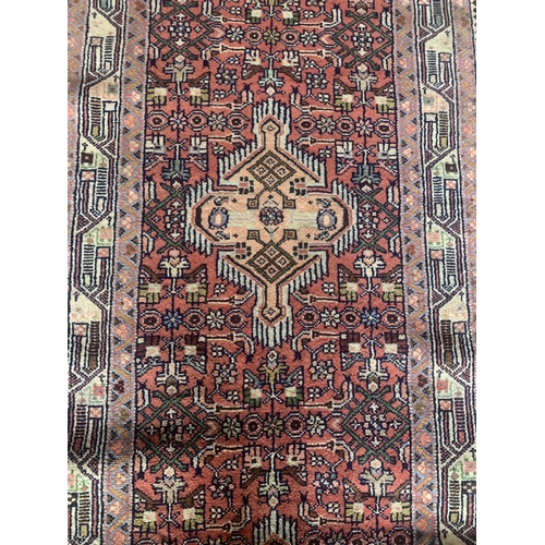 1445 - Good Persian Malayer runner, intricate three medallion design on washed red ground, 285 x 90cm