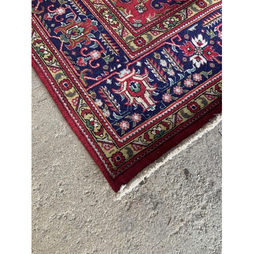 1446 - Superior North West Persian Heriz Country House carpet, traditional central blue medallion on red gr... 