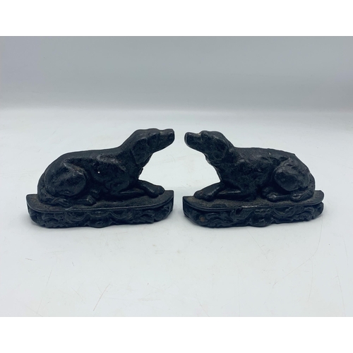 2395 - Pair of small cast iron door stops in the form of recumbent hounds, H 10cm