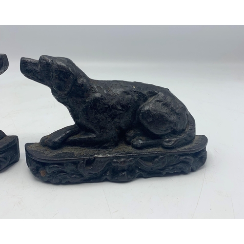 2395 - Pair of small cast iron door stops in the form of recumbent hounds, H 10cm