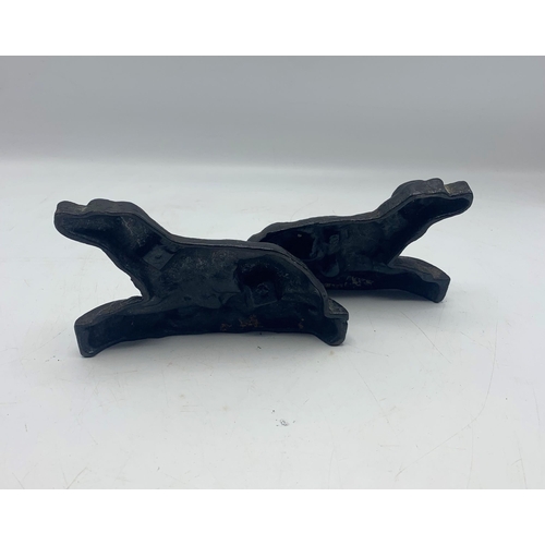 2395 - Pair of small cast iron door stops in the form of recumbent hounds, H 10cm