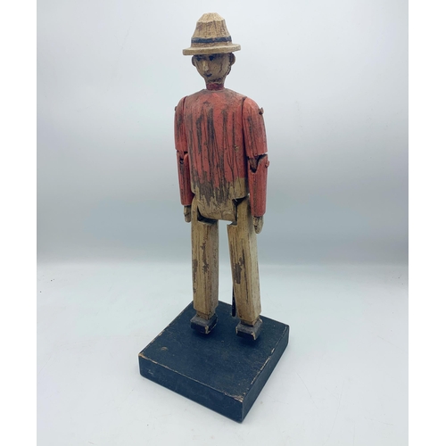 2303 - Carved Wooden Folk Art Sculpture Of Articulated Man Atop Wooden Base. H 44cm.