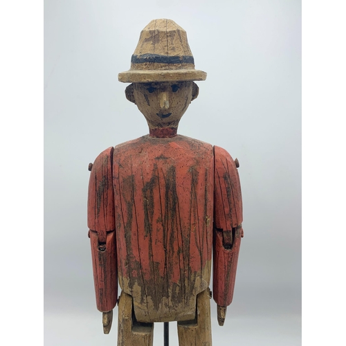 2303 - Carved Wooden Folk Art Sculpture Of Articulated Man Atop Wooden Base. H 44cm.