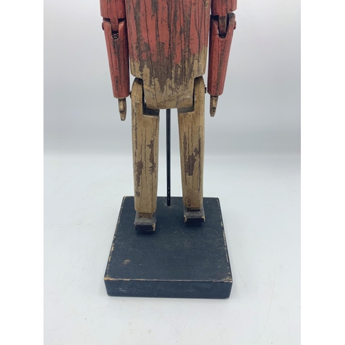 2303 - Carved Wooden Folk Art Sculpture Of Articulated Man Atop Wooden Base. H 44cm.