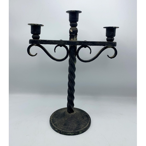 1111 - Twisted stem wrought iron three sconce candelabra piece. H 42cm W 29cm.