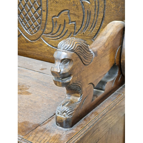 1307 - Carved oak fold over top monk's bench with box base, H 74cm x W 92cm x D 47cm