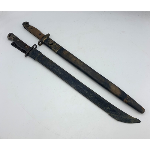 2411 - Two First World War British 1907 pattern bayonets with fullered blades and wooden grips, both stampe... 