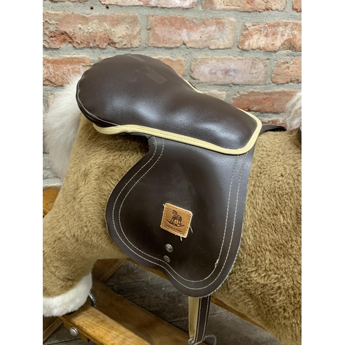 320 - Large Mamas & Papas children's rocking horse with wooden base & leather saddle. L 90cm x H 80cm