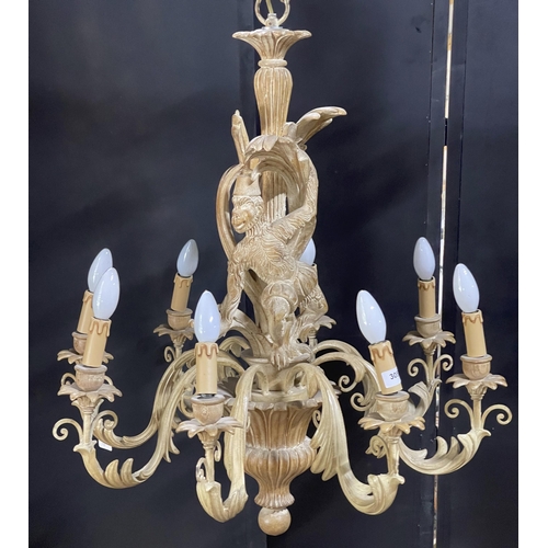 1120 - Good quality Italian carved softwood eight branch chandelier, centrally decorated with a monkey hold... 