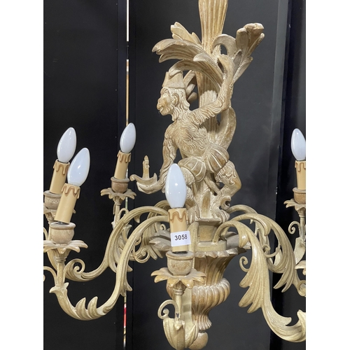 1120 - Good quality Italian carved softwood eight branch chandelier, centrally decorated with a monkey hold... 