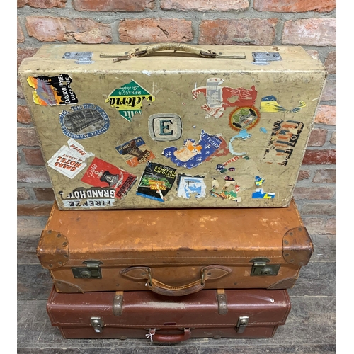 2428 - Four large vintage suitcases to include two vellum examples one with exotic travel stickers and a ba... 