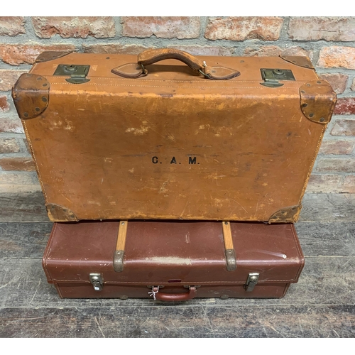 2428 - Four large vintage suitcases to include two vellum examples one with exotic travel stickers and a ba... 