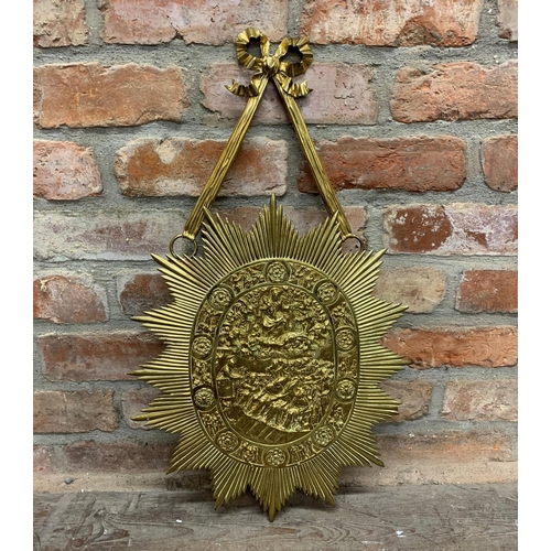 2403 - Unusual large gilt brass sunburst shield, on ribbon hanging bracket, embossed with a biblical scene,... 