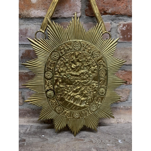 2403 - Unusual large gilt brass sunburst shield, on ribbon hanging bracket, embossed with a biblical scene,... 