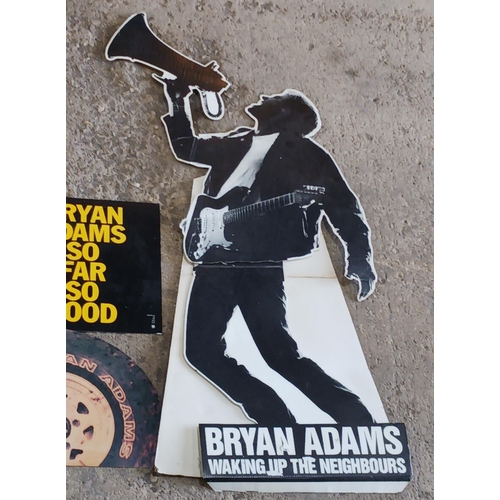 114 - Bryan Adams 'waking up the neighbours' promotional cardboard cutout together with three other promot... 