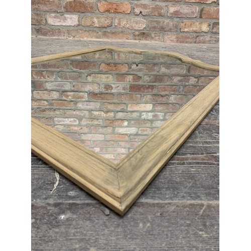 1077 - Oka of London limed oak framed arch panelled mirror, 100 x 80cm