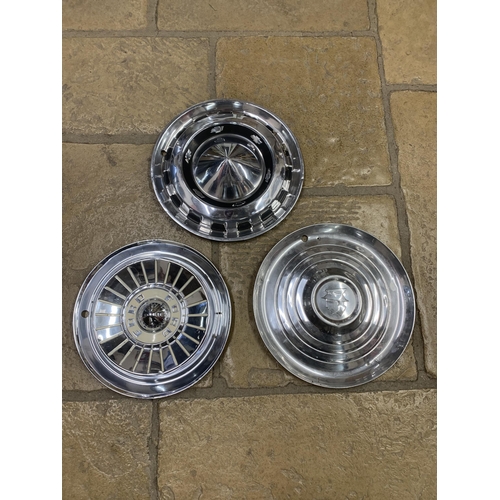 1023A - Three vintage hubcaps to include Ford, Chevrolet and Mercury (3)