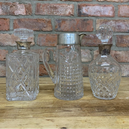 178 - Two silver collared decanters with additional silver rimmed jug (3)