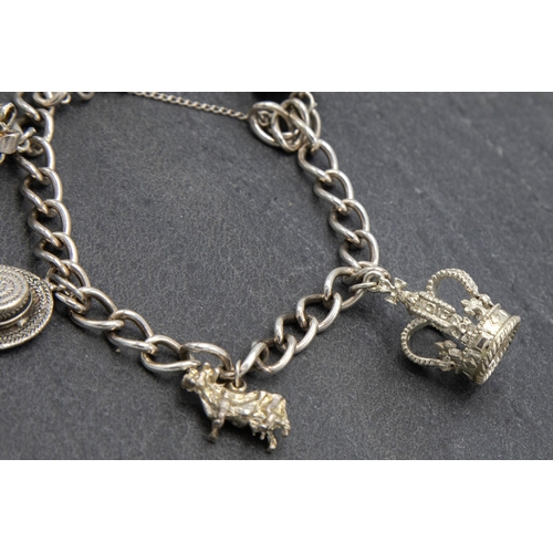 57 - Silver charm bracelet with five charms and heart padlock clasp, 19cm long, 34g